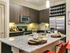 Modern kitchen with pendant lighting, island, wine rack, stainless steel appliances and concrete flooring