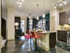 Beautiful, spacious living and kitchen area with large islands, concrete flooring, stainless steel appliances and pendant lighting