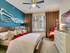 Spacious master bedroom with ceiling fan and plush carpet