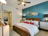 Spacious master bedroom with ceiling fan and plush carpet