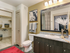 Elegant, spa-like bathrooms with dark cabinetry, granite countertops and walk-in closets
