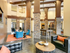 Stunning community clubhouse with lounge seating, concrete flooring and pendant lighting
