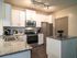 Apartments for Rent in West Nashville TN - Summit at Nashville West Apartments - Kitchen with Grainte-style Countertops, White Cupboards, Stainless Steel Appliances, and a Kitchen Island