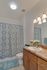 Bathroom with shaker style cabinets, single sink and tub/shower combo