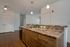 Kitchen with shaker style cabinets, pendant lights and wood plank flooring