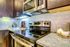 Kitchen with espresso cabinets, stainless steel appliance package and granite countertop and underlight cabinets