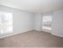 carpeted bedroom with grey walls and white trim