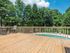 sundeck overlooking the pool surrounded by trees