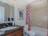 bathroom with standard tub and storage