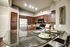 Beautiful kitchen featuring an island, stainless steel appliances, tile back splash and granite counter tops.