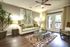 Spacious Living Room, 9 Foot Ceilings, Open concept floor plan, with natural light. Ceiling fan and faux wood flooring.