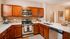 Open concept modern kitchen with quartz countertops and stainless steel appliances