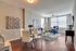 Luxury spacious open living room. Large windows, with natural light. Plank floors