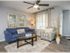 View of living room with hardwood inspired flooring and ceiling fan