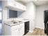 Kitchen with white shaker cabinets and black appliances