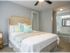 Bedroom with plush carpeting and adjascent bathroom