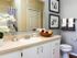 bathroom with large countertop and storage