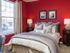 bedroom with large window, full sized bed and two night stands