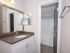 Water closet in the bathroom with framed mirror