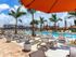 Treviso Grand Apartments - North Venice, Florida pool side lounge chairs and umbrella