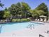 Sparkling pool with poolside lounge furniture and umbrellas