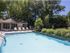 Sparkling pool with poolside lounge furniture and umbrellas