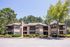 Exterior photo of 2 story building with siding and exterior patios