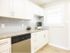 Modern kitchen with white cabinets, subway tile backsplash, and granite countertops