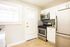 Modern kitchen with white cabinets, subway tile backsplash, and granite countertops