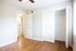 Bedroom with plank flooring and light grey walls