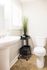 Updated, light and airy bathroom with a pedestal sink and shower/tub combo