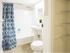 Updated, light and airy bathroom with a pedestal sink and shower/tub combo