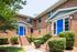 Exterior entryways with blue doors surrounded by trees