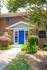 Exterior entryways with blue doors surrounded by trees