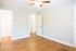 Bedroom with plank flooring and light grey walls