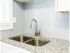 Modern kitchen with white cabinets, subway tile backsplash, and granite countertops