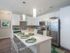Ridgelake, interior, kitchen, breakfast bar island, wood floor, stainless steal appliances, refrigerator, stove/oven, microwave, dishwasher, white cabinets, high ceilings