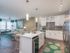 Ridgelake, interior, kitchen, breakfast bar island, wood floor, stainless steal appliances, refrigerator, stove/oven, microwave, dishwasher, white cabinets, high ceilings, living room, large windows