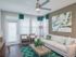 Ridgelake, interior, living room, large windows, door, white sofa, arm chairs, green area rug, ceiling fan,