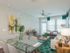 Ridgelake, interior, dining room, living room, green area rug, high ceilings, large windows, door, glass table, chairs, sofa, ceiling fan