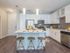 Ridgelake, interior, kitchen, breakfast bar island, wood floor, stainless steal appliances, refrigerator, stove/oven, microwave, dishwasher, white cabinets, high ceilings