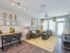 Ridgelake, interior, living room, large windows, door, area rug, yellow accents, ceiling fan, sofa, dining table