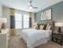 Ridgelake, interior, bedroom, carpet, large bed, two windows, blue and yellow accents,