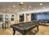 The Henry Apartments, interior, billiard table, wood floors, spacious, tables and chairs, table tennis, refrigerator, windows to fitness center