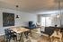The Henry Apartments, interior, dining room living room, table, chairs, area rugs, tv, sectional sofa, large sliding glass doors