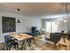 The Henry Apartments, interior, dining room living room, table, chairs, area rugs, tv, sectional sofa, large sliding glass doors