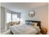 The Henry Apartments, interior, bedroom, spacious, large bed, natural light, windows, carpet, round mirror, seating area