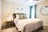 Guest Bedroom with Window and Faux wood flooring