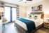 Master Bedroom with double doors that lead to the patio and faux wood flooring
