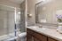 San Mateo Apartments Kissimmee Florida restroom with walk-in shower and framed mirror